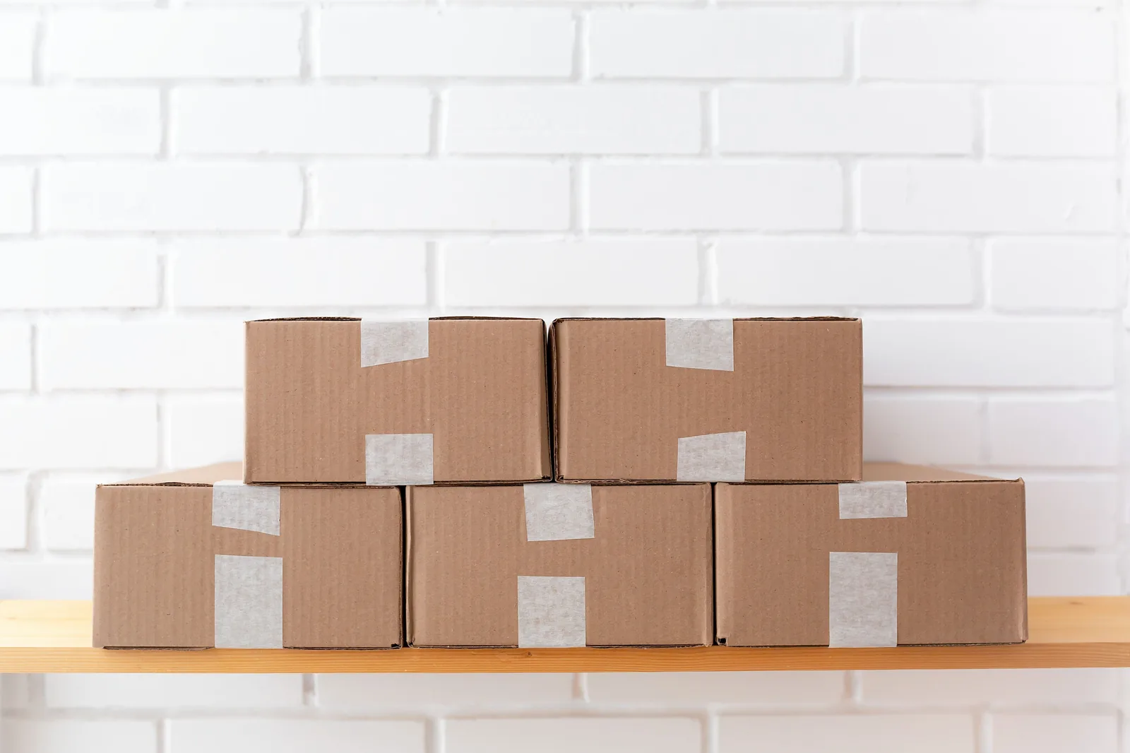 Taped corrugated cartons stacked on a shelf