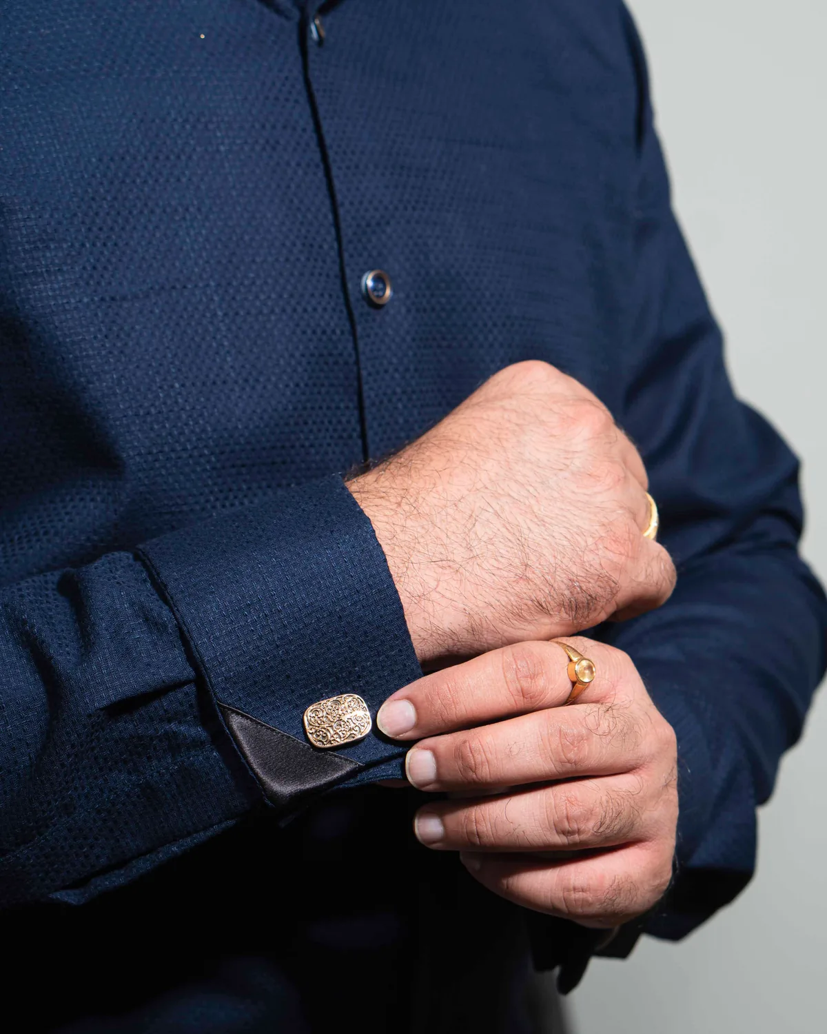 Navy textured long-sleeve formal shirt with a French cuff fastened by a cufflink