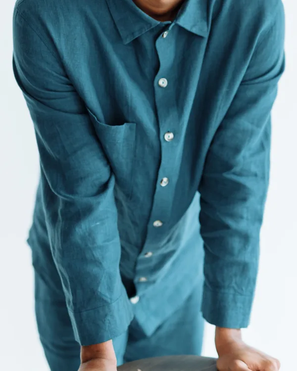 Teal long-sleeve linen shirt with point collar and patch pocket, worn and shown from the neck down