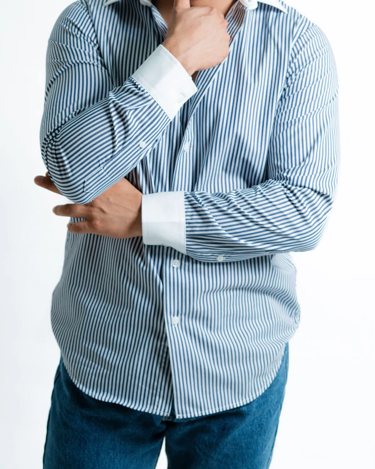 Navy and white bengal-stripe long-sleeve shirt with white contrast collar and cuffs, shown from the neck down on a white studio background